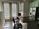 Granite-topped kitchen island with seating area, stainless-steel refrigerator and access to the patio at 4666 Magnolia Commons, Dunwoody, GA 30338
