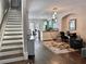 Open-concept living area featuring hardwood floors, a staircase, and a combined dining-kitchen space at 4666 Magnolia Commons, Dunwoody, GA 30338