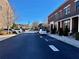 Community street view showcasing brick townhouses with reserved parking spaces at 4666 Magnolia Commons, Dunwoody, GA 30338