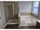 Bathroom featuring a soaking tub, tiled shower, and modern fixtures at 7214 Bedrock Cir, Lithonia, GA 30038