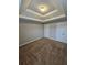 Bedroom featuring neutral walls, carpet, and tray ceiling at 7214 Bedrock Cir, Lithonia, GA 30038
