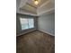 Bedroom showcasing neutral walls, carpet and tray ceiling at 7214 Bedrock Cir, Lithonia, GA 30038