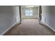 Spacious dining room featuring wainscoting, columns, and a modern chandelier at 7214 Bedrock Cir, Lithonia, GA 30038