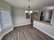 Open-concept dining area with wood floors, granite countertop and view to kitchen at 7214 Bedrock Cir, Lithonia, GA 30038