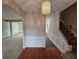 Elegant foyer featuring hardwood floors, a staircase, and a decorative chandelier at 7214 Bedrock Cir, Lithonia, GA 30038