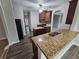 Open kitchen layout with stainless steel appliances, center island and sleek cabinetry at 7214 Bedrock Cir, Lithonia, GA 30038