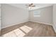 Bedroom features light-colored walls, fan, and natural light from a window at 1179 Church St # J, Decatur, GA 30030