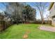 Large, fenced backyard with lush green grass and a patio area at 2750 Dominion Walk Ln, Snellville, GA 30078