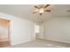 Spacious bedroom with neutral carpet, ceiling fan, and an ensuite bathroom is bathed in natural light at 2750 Dominion Walk Ln, Snellville, GA 30078