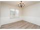 Dining room featuring stylish hardwood floors, elegant wall trim, and a classic chandelier at 2750 Dominion Walk Ln, Snellville, GA 30078