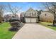 Charming home featuring a two-car garage, landscaped yard, and traditional architectural details at 2750 Dominion Walk Ln, Snellville, GA 30078