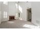 Bright living room featuring carpeted floors, a fireplace, and large windows offering plenty of light at 2750 Dominion Walk Ln, Snellville, GA 30078