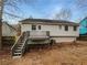 Rear view of the home showcasing a large wooden deck, a well-maintained exterior, and backyard at 3764 Cherokee Overlook Dr, Canton, GA 30115