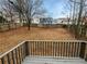 Large fenced backyard seen from wooden deck, featuring mature trees and ample green space at 3764 Cherokee Overlook Dr, Canton, GA 30115