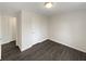 Bedroom with light walls, dark wood-look floors, white trim and doors, and a single light fixture at 3764 Cherokee Overlook Dr, Canton, GA 30115