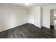 Bedroom with light walls, dark wood-look floors, white trim and doors, and a single light fixture at 3764 Cherokee Overlook Dr, Canton, GA 30115