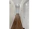 Hallway with laminate flooring and white doors at 3764 Cherokee Overlook Dr, Canton, GA 30115