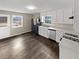 Spacious kitchen featuring white cabinetry, modern appliances, and laminate flooring at 3764 Cherokee Overlook Dr, Canton, GA 30115