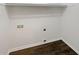 A utility/laundry room with hookups, white walls, white trim, white rod and dark wood-look floors at 3764 Cherokee Overlook Dr, Canton, GA 30115