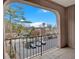 Balcony view overlooking parking area, mature trees and adjacent buildings under a blue sky at 395 Pharr Ne Rd # 301, Atlanta, GA 30305