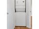 Modern stacked washer and dryer in an alcove with closet door at 395 Pharr Ne Rd # 301, Atlanta, GA 30305