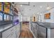 Entertaining bar area featuring stainless appliances, custom cabinets, shelving, and unique garage door window to covered porch at 4115 Merritt Dr, Cumming, GA 30041