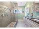 Modern bathroom with a stone tiled shower, double vanity and lots of natural light at 4115 Merritt Dr, Cumming, GA 30041