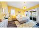 Sunny primary bedroom with wood floors, stylish decor and outdoor access at 4115 Merritt Dr, Cumming, GA 30041