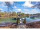 Stunning lake view featuring a private dock with boat slip on a clear day, surrounded by lush trees and natural beauty at 4115 Merritt Dr, Cumming, GA 30041