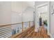 An upstairs hallway features wood floors, a chandelier, and railing at 4115 Merritt Dr, Cumming, GA 30041