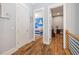 Upstairs hallway with wood floors offering views into the nautical themed bedroom and office at 4115 Merritt Dr, Cumming, GA 30041