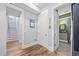 Hallway with wood floors, neutral walls, white trim, and access to the stairs and bathroom at 4115 Merritt Dr, Cumming, GA 30041