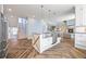 Modern kitchen island with stainless sink and view into the living room at 4115 Merritt Dr, Cumming, GA 30041