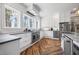 Bright kitchen with herringbone floors, stainless appliances, white cabinets, and natural light at 4115 Merritt Dr, Cumming, GA 30041