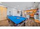 Recreation room boasting a pool table, barn door, and built-in wet bar for entertainment at 4115 Merritt Dr, Cumming, GA 30041