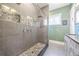 Contemporary bathroom features gray tile, pebble accents, a glass shower, and dual vanities at 4115 Merritt Dr, Cumming, GA 30041