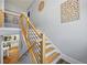 Open staircase with wooden steps and modern metal railings, leading to a bright, open living space at 4115 Merritt Dr, Cumming, GA 30041