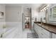 Elegant bathroom with a soaking tub, vanity, and ample storage, leading to a serene and well-lit bedroom at 10 Clarke Hill St, Decatur, GA 30030