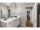 Well-lit bathroom with a large mirror, a vanity with white cabinets, and neutral color tones at 10 Clarke Hill St, Decatur, GA 30030