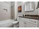 Modern bathroom featuring tiled walls, a shower-tub combination, and a sleek vanity with ample storage at 10 Clarke Hill St, Decatur, GA 30030