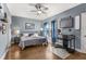 Bedroom with a ceiling fan, hardwood floors, gray walls, and a bed with matching gray bedding at 10 Clarke Hill St, Decatur, GA 30030