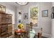 Cozy dining area with a round glass table, wooden chairs, and natural light from the backyard view at 10 Clarke Hill St, Decatur, GA 30030