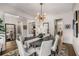 Bright dining room featuring stylish light fixture, a dining table with seating, and access to other living spaces at 10 Clarke Hill St, Decatur, GA 30030