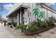 Stylish restaurant exterior with a unique tropical mural, lush greenery, and a covered entrance at 10 Clarke Hill St, Decatur, GA 30030