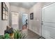 Hallway with tile floors, a plant, and access to a bathroom, bedroom, and an external entrance at 10 Clarke Hill St, Decatur, GA 30030