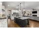 Open concept kitchen with granite counters, a black island and stainless steel appliances that opens to the living room at 10 Clarke Hill St, Decatur, GA 30030