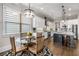 Bright eat-in kitchen featuring white cabinets, stainless steel appliances, and a round glass dining table at 10 Clarke Hill St, Decatur, GA 30030