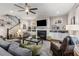 Spacious living room featuring a ceiling fan, fireplace, and large windows for natural light at 10 Clarke Hill St, Decatur, GA 30030