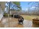 Back deck with a grill, fire pit, and a view of the spacious backyard at 21 Cass Station Pass Nw Pass, Cartersville, GA 30121