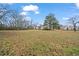 Wide-open backyard with mature trees and distant neighboring home at 21 Cass Station Pass Nw Pass, Cartersville, GA 30121